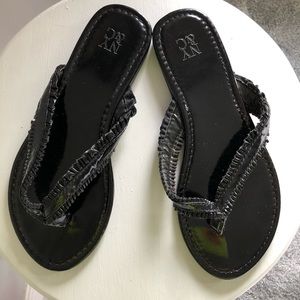 Shiny black flip flops